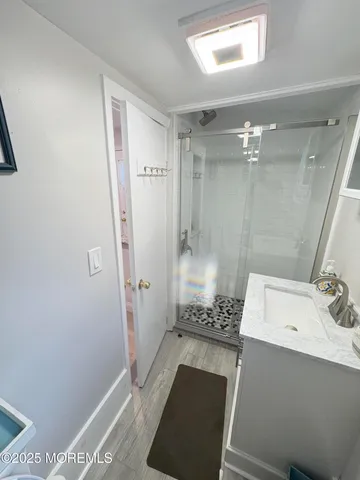 a bathroom with a sink a toilet and shower