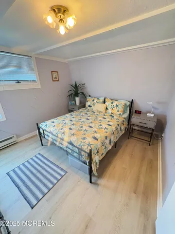 a bed sitting in a bedroom next to a lamp