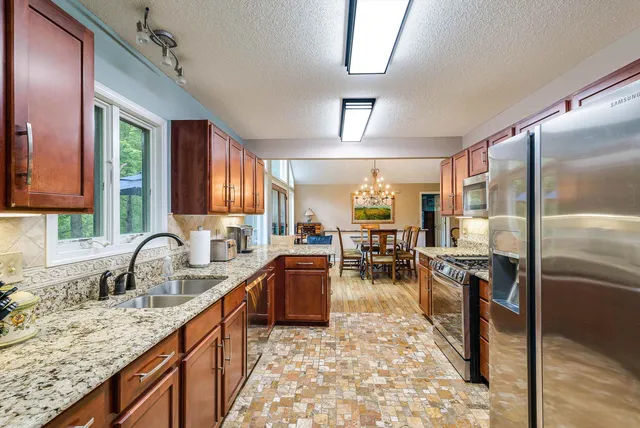 a view of a two chairs and table under an umbrella on wooden deck