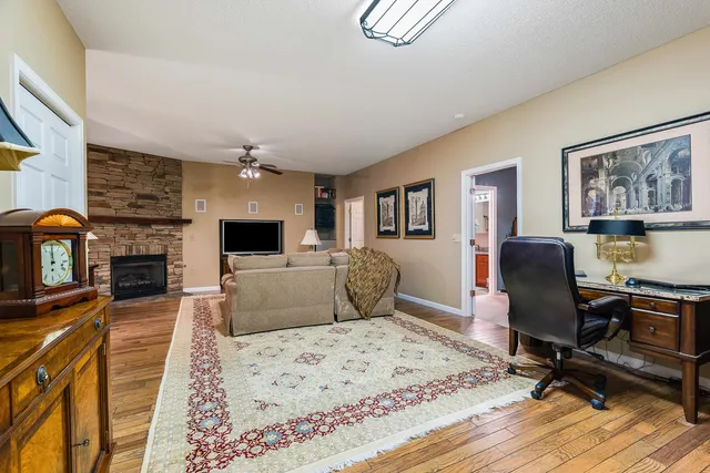 a bathroom with a granite countertop sink a toilet and a mirror