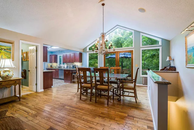 a view of a dining room with furniture and chandelier