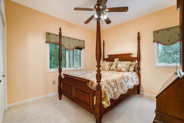 a view of a lush green forest with a house