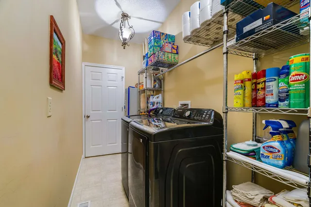 an aerial view of residential houses with outdoor space and trees