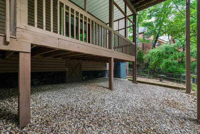 a view of a patio with table and chairs next to a yard