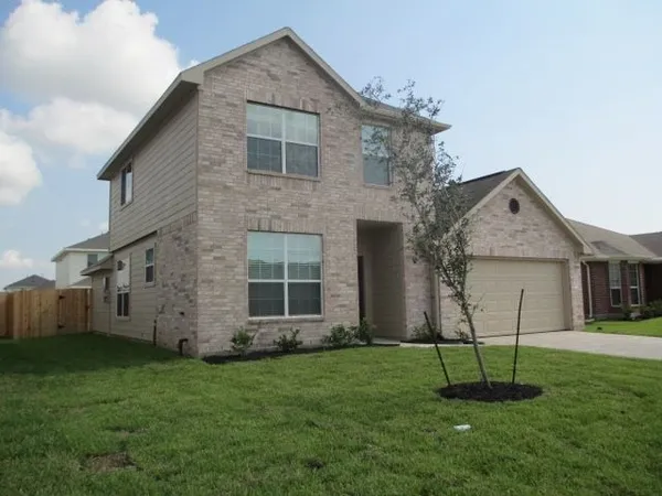 a view of a house with a yard and a garden