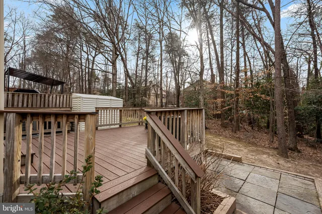 a view of a balcony with wooden floor and fence