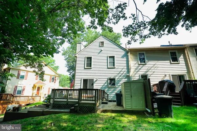 a view of house with a backyard