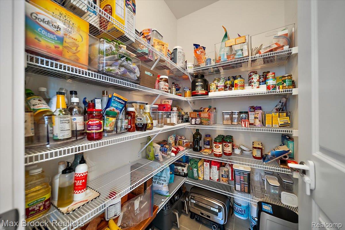 1942 Nottingham Drive Rochester, MI 48307 - Photo 30 of 97 Corner pantry featuring extensive wire shelving, white walls, and a white interior door