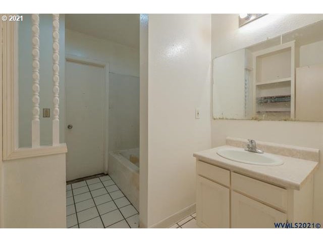 34415 Bond Road Lebanon, OR 97355 - Photo 13 of 32 a bathroom with a sink a toilet and a mirror