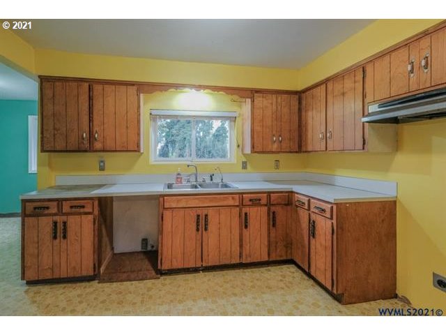 34415 Bond Road Lebanon, OR 97355 - Photo 19 of 32 a kitchen with granite countertop wooden cabinets