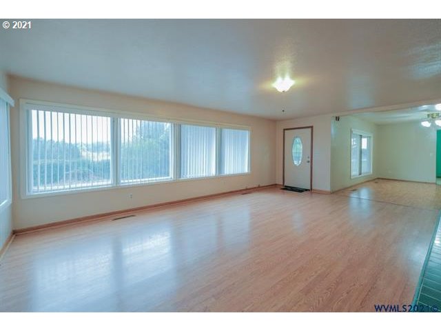34415 Bond Road Lebanon, OR 97355 - Photo 3 of 32 a view of an empty room with wooden floor and a window