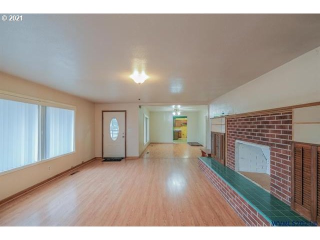 34415 Bond Road Lebanon, OR 97355 - Photo 10 of 32 a view of empty room with wooden floor and fireplace