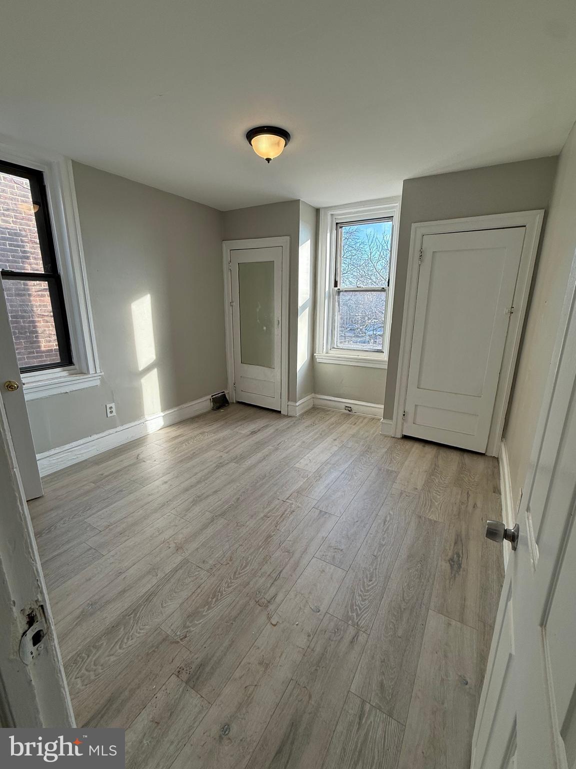 4843 Palethorp Street Philadelphia, PA 19120 - Photo 4 of 16 a view of an empty room with wooden floor and a window