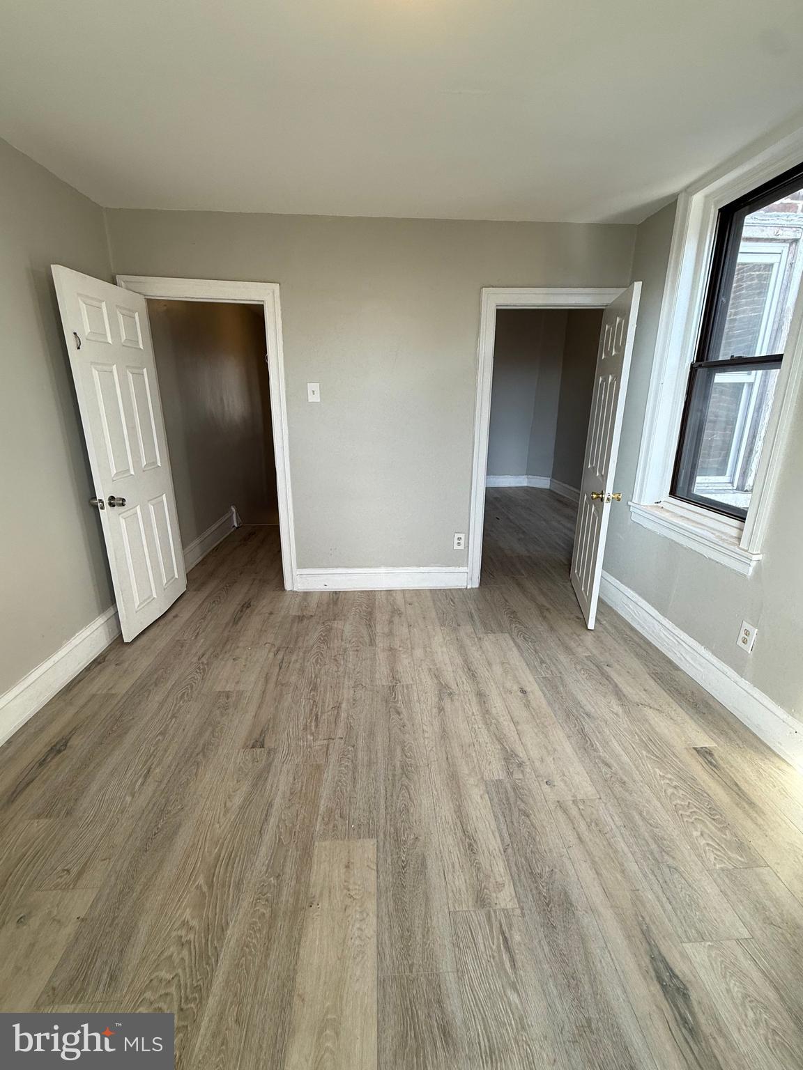 4843 Palethorp Street Philadelphia, PA 19120 - Photo 5 of 16 an empty room with wooden floor and windows
