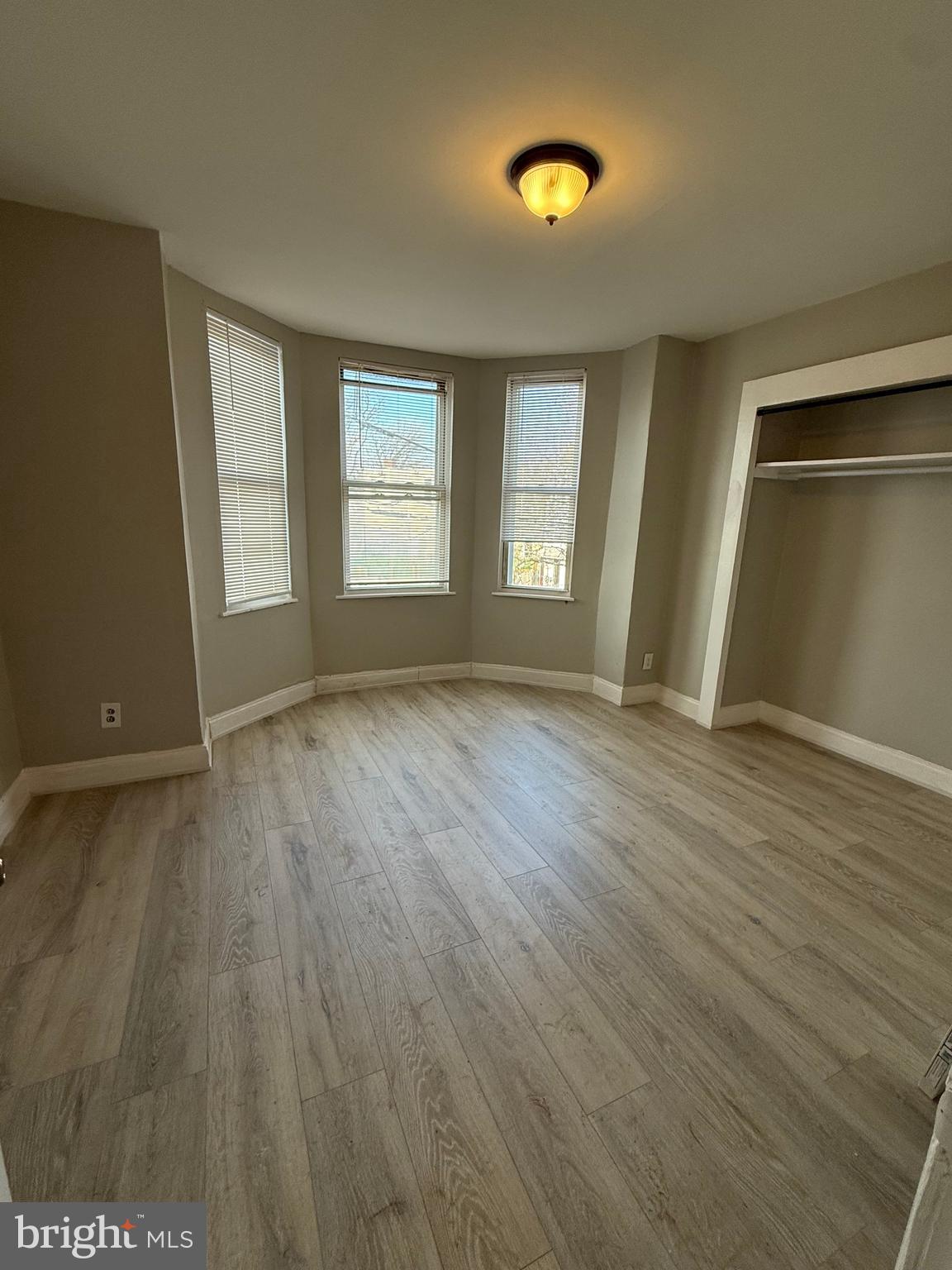 4843 Palethorp Street Philadelphia, PA 19120 - Photo 8 of 16 an empty room with wooden floor and windows