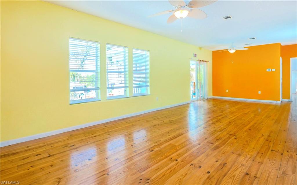 12277 Boat Shell Drive Matlacha Isles, FL 33991 - Photo 12 of 46 a view of an empty room with wooden floor and a window