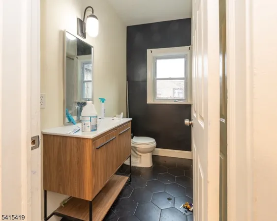 a bathroom with a sink toilet and mirror