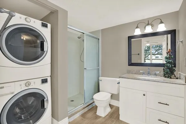 a bathroom with a sink mirror and toilet