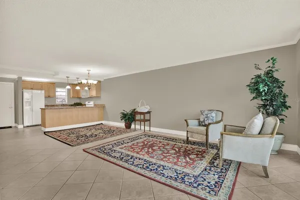 a living room with furniture and a dining table