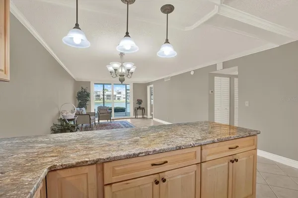 a view of a kitchen with granite countertop cabinets and wooden floor