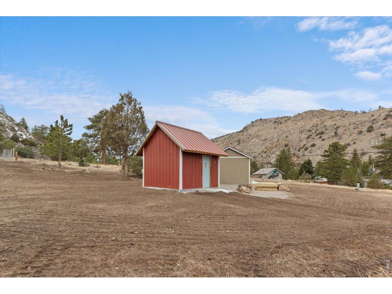 59 Rustic Road Bellvue, CO 80512 - Photo 11 of 21 a view of dirt road with a building in the background