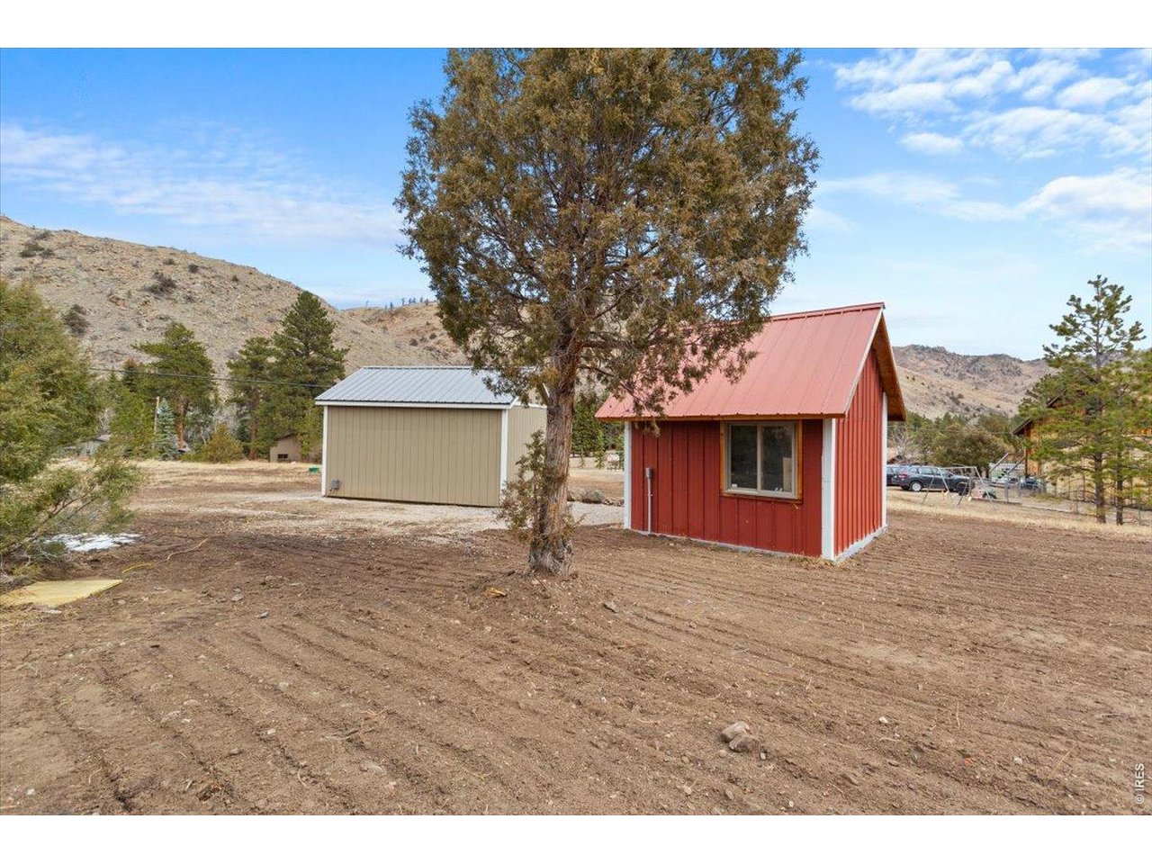 59 Rustic Road Bellvue, CO 80512 - Photo 2 of 21 a view of a house with a yard and garage