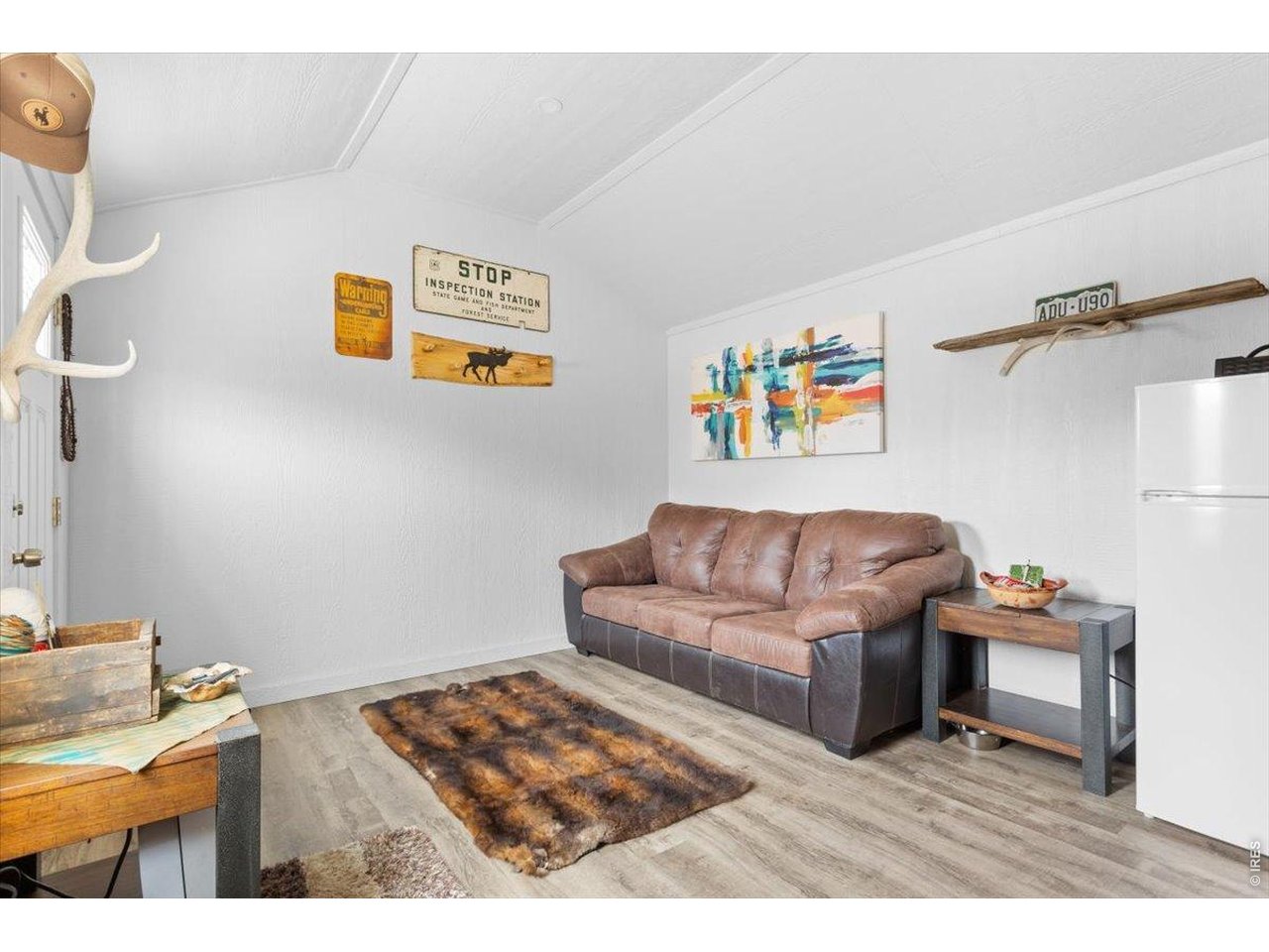 59 Rustic Road Bellvue, CO 80512 - Photo 7 of 21 a living room with furniture and a flat screen tv