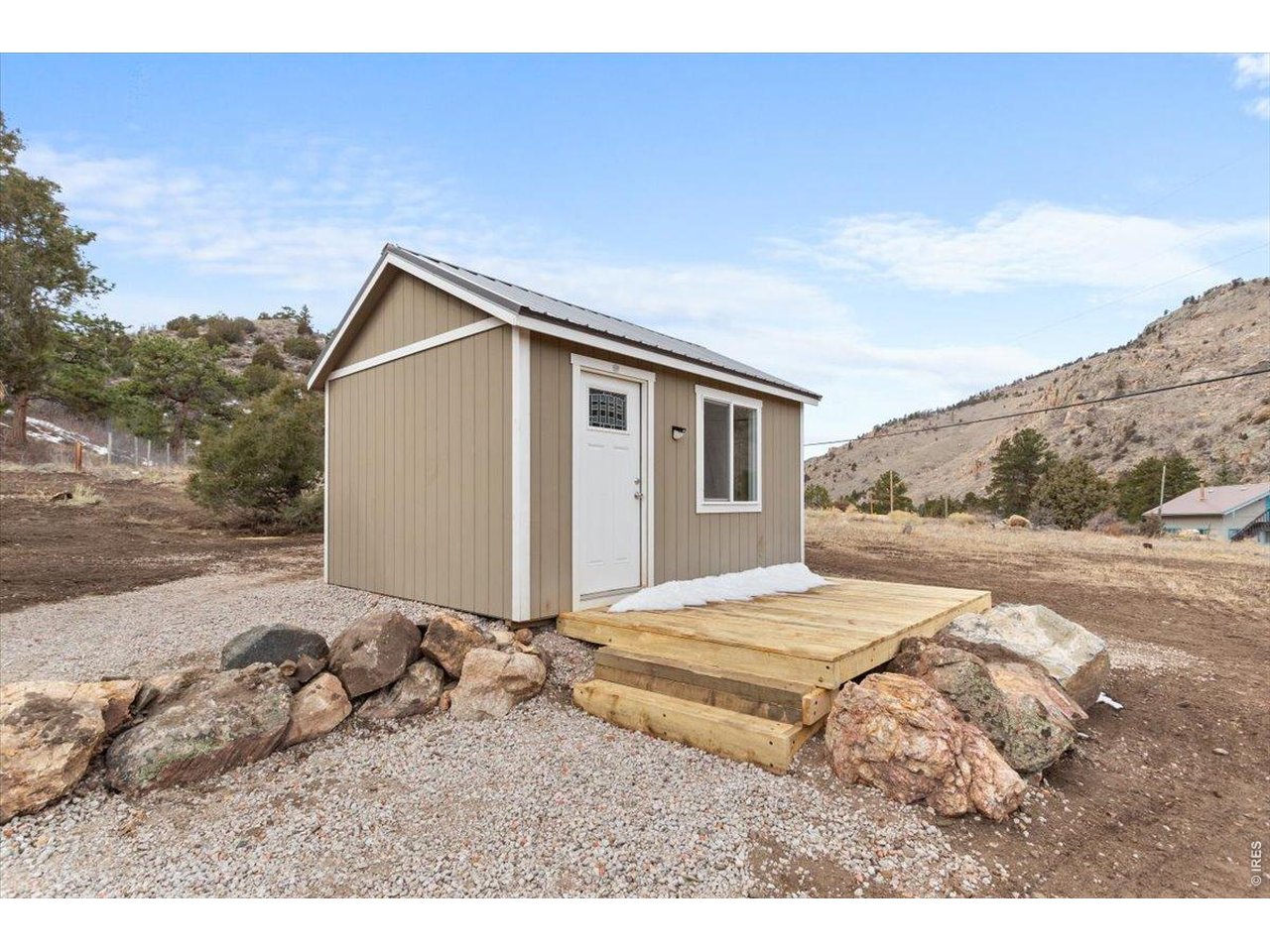 59 Rustic Road Bellvue, CO 80512 - Photo 8 of 21 a backyard of a house with wooden fence