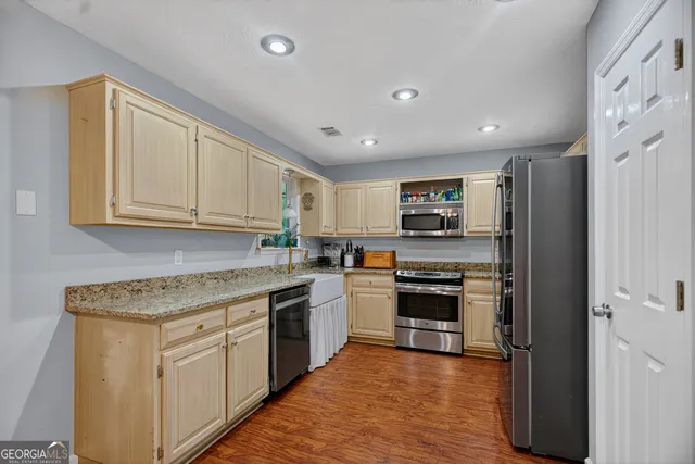 a kitchen with stainless steel appliances granite countertop a stove and a sink