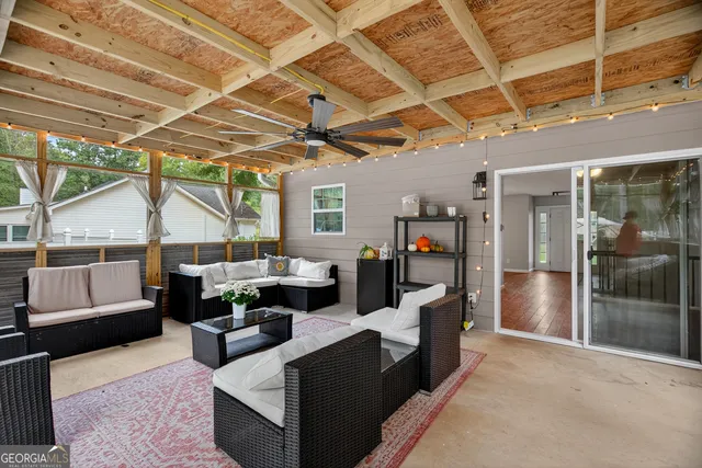 a living room with furniture and a glass door