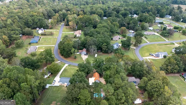 an aerial view of residential houses with outdoor space and swimming pool