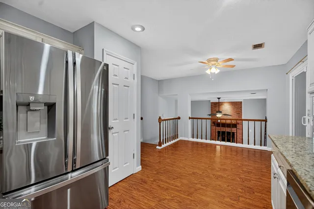 a kitchen with stainless steel appliances granite countertop a refrigerator stove and sink