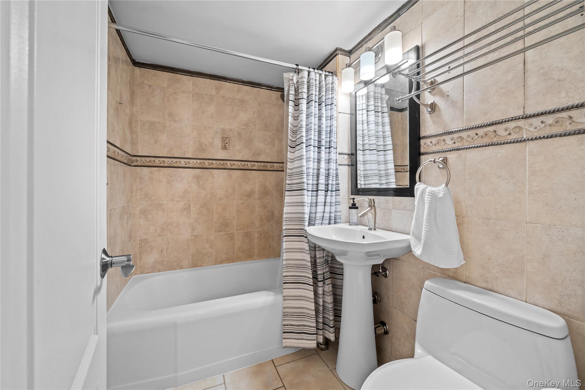 4555 Henry Hudson Parkway West, Unit A908 Bronx, NY 10471 - Photo 11 of 12 a bathroom with a sink toilet and shower