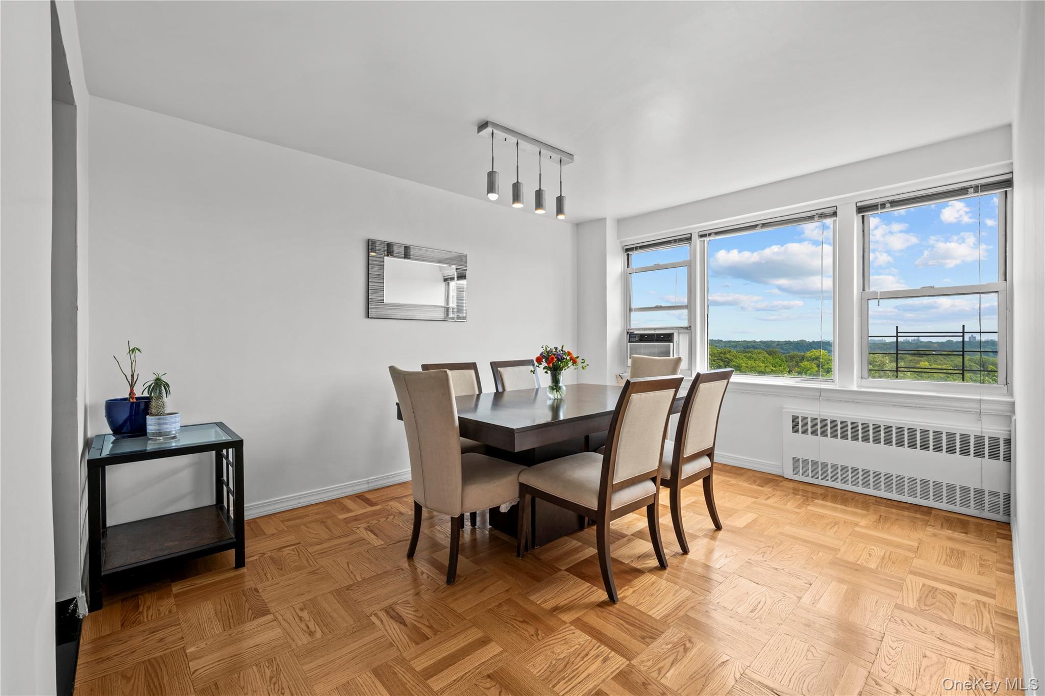 4555 Henry Hudson Parkway West, Unit A908 Bronx, NY 10471 - Photo 2 of 12 a view of a dining room with furniture window and outside view