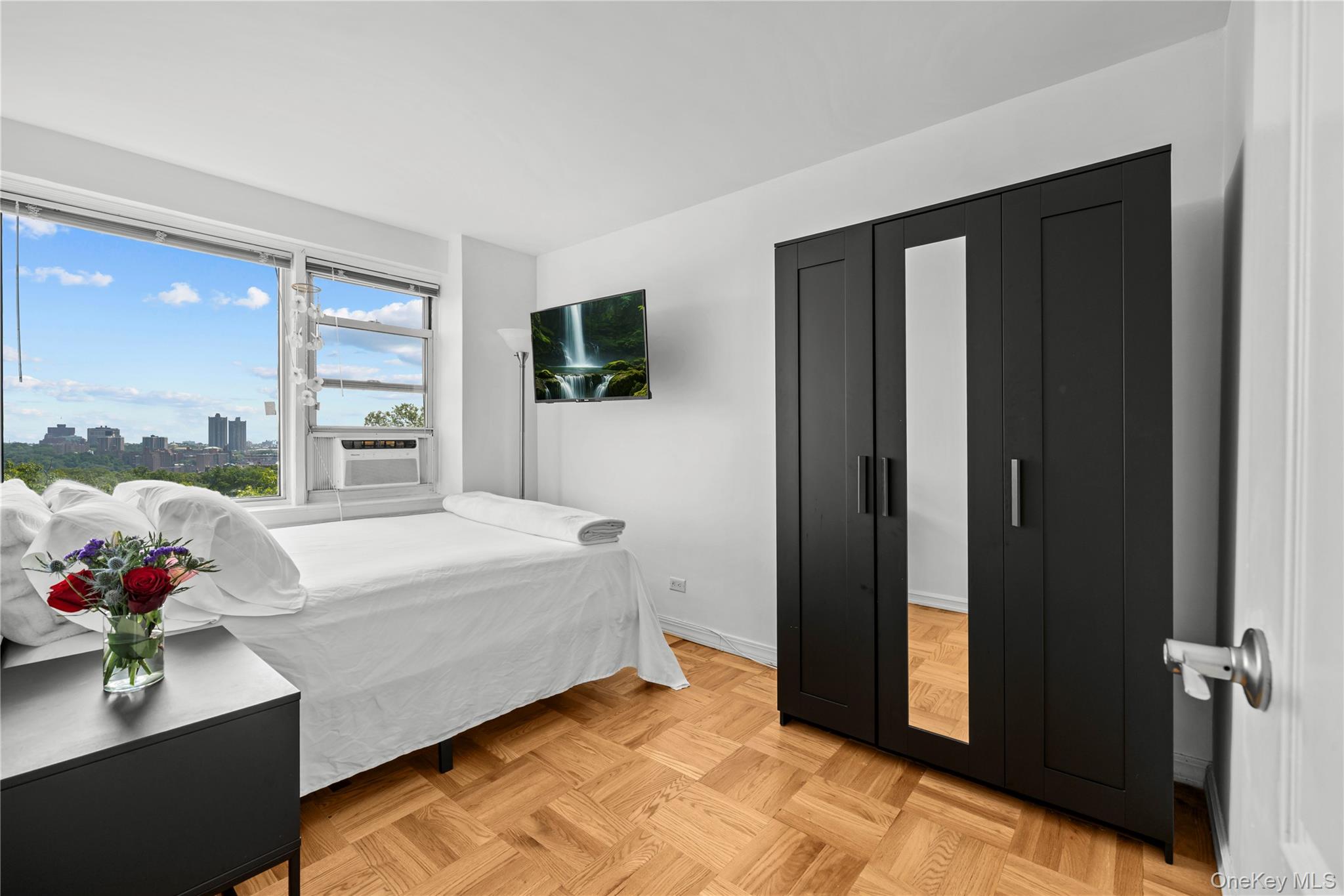 4555 Henry Hudson Parkway West, Unit A908 Bronx, NY 10471 - Photo 8 of 12 a spacious bedroom with a bed and a potted plant