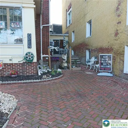a view of a street with potted plants