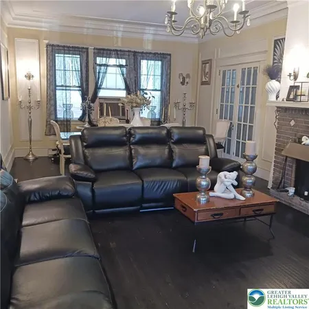a living room with furniture and a chandelier