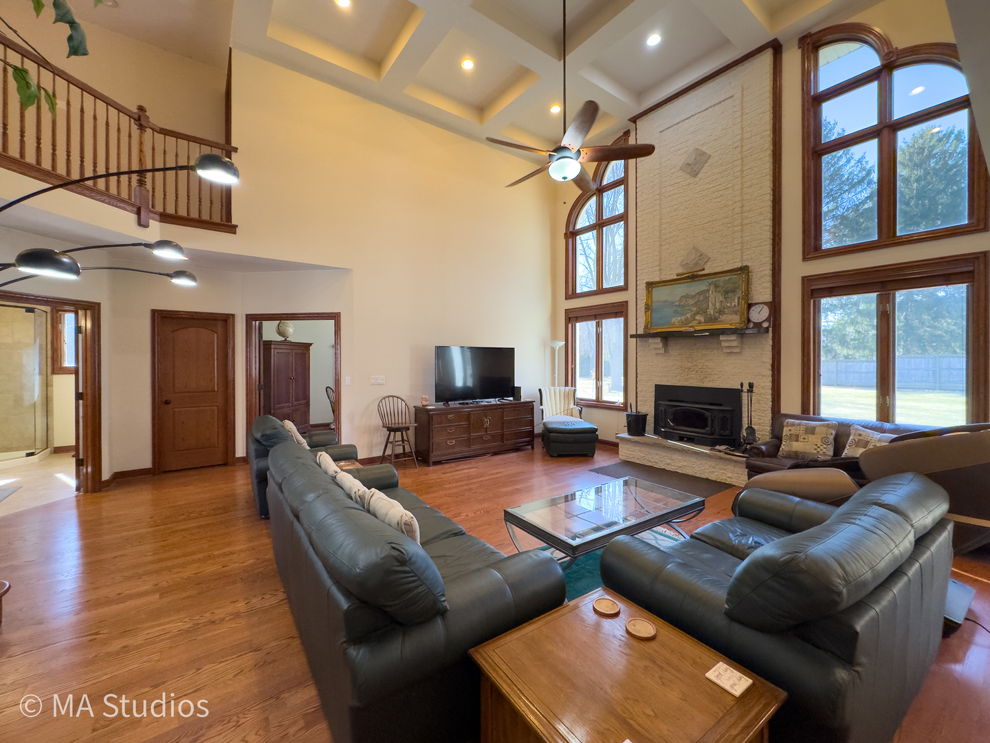 9030 Elm Avenue Burr Ridge, IL 60527 - Photo 12 of 72 a living room with furniture a fireplace and a ceiling fan