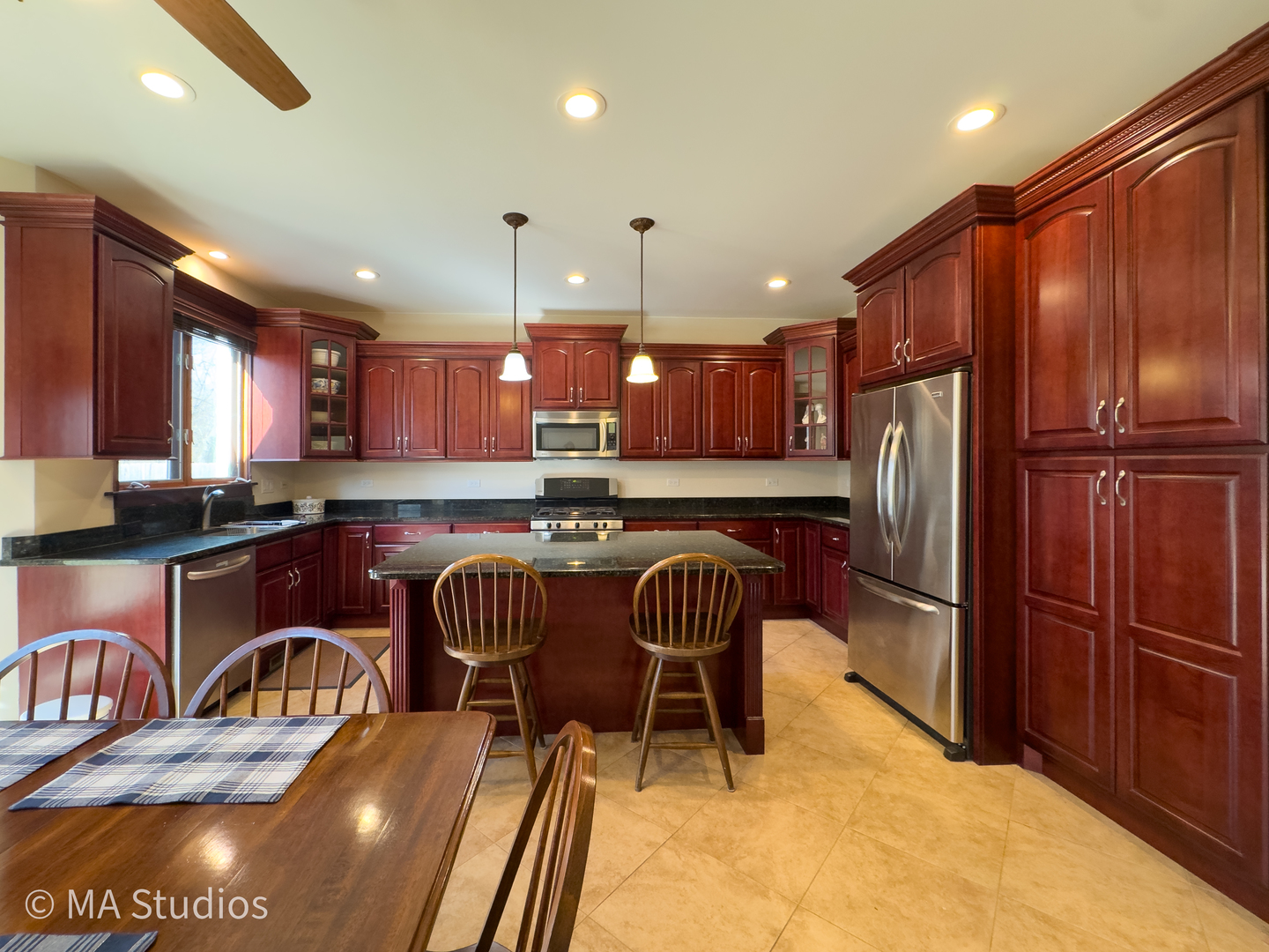 9030 Elm Avenue Burr Ridge, IL 60527 - Photo 18 of 72 a kitchen with stainless steel appliances granite countertop a refrigerator a sink a stove a dining table and chairs with wooden floor
