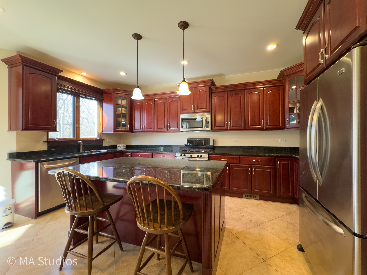 9030 Elm Avenue Burr Ridge, IL 60527 - Photo 19 of 72 a kitchen with stainless steel appliances granite countertop a sink a stove a refrigerator cabinets and chairs