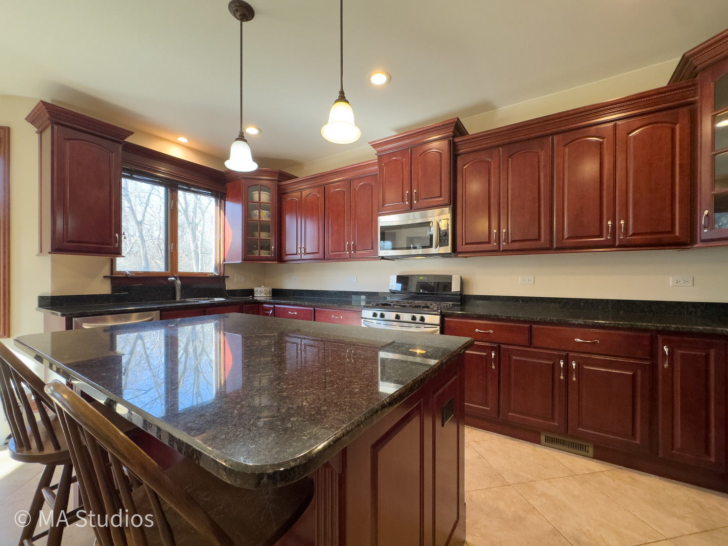 9030 Elm Avenue Burr Ridge, IL 60527 - Photo 20 of 72 a kitchen with a stove a sink a center island a counter space and a window