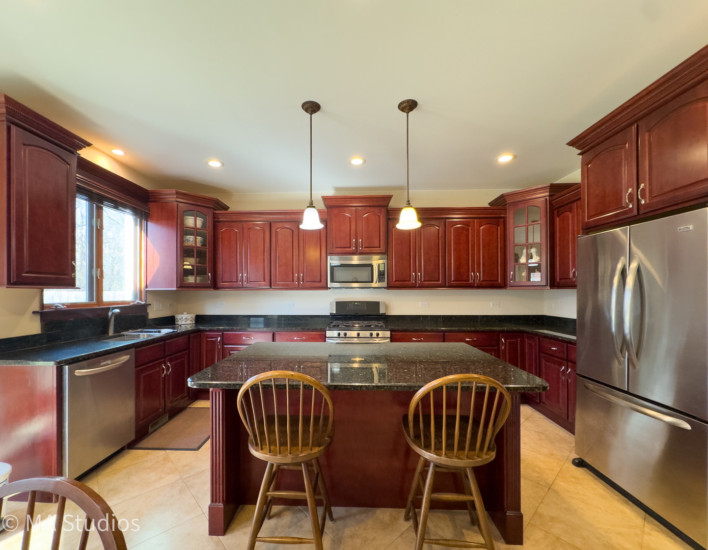 9030 Elm Avenue Burr Ridge, IL 60527 - Photo 21 of 72 a kitchen with stainless steel appliances granite countertop a kitchen island a table and chairs