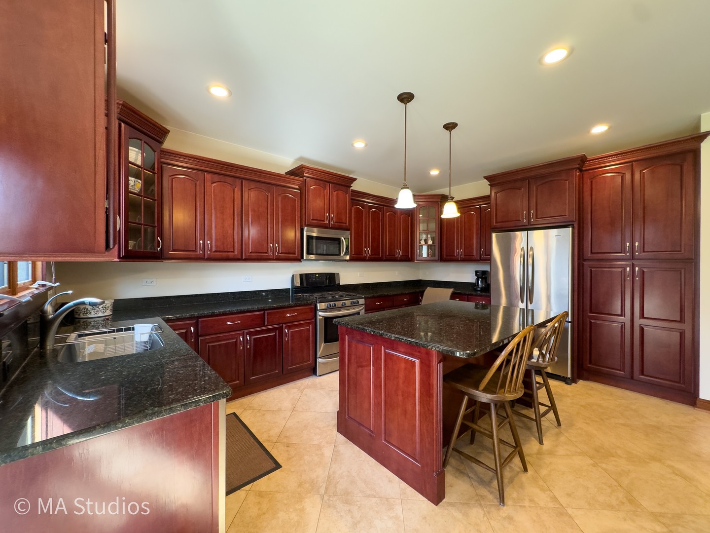 9030 Elm Avenue Burr Ridge, IL 60527 - Photo 22 of 72 a kitchen with stainless steel appliances granite countertop a stove refrigerator sink and cabinets