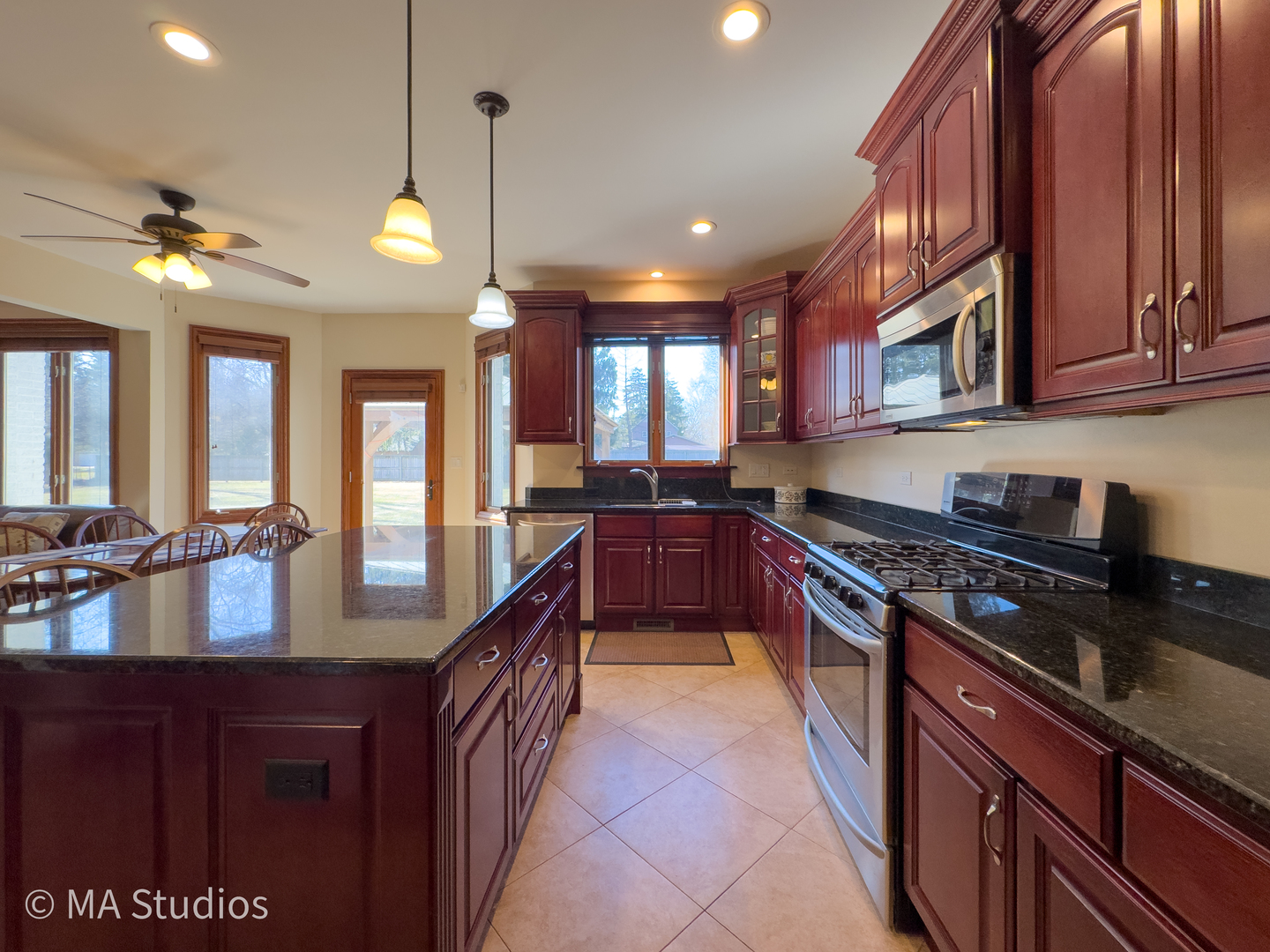 9030 Elm Avenue Burr Ridge, IL 60527 - Photo 25 of 72 a large kitchen with stainless steel appliances granite countertop a stove a sink and a microwave