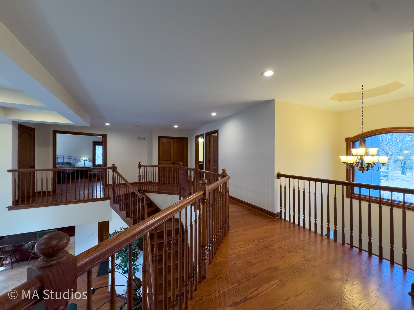 9030 Elm Avenue Burr Ridge, IL 60527 - Photo 31 of 72 a view of a hallway with wooden floor and stairs