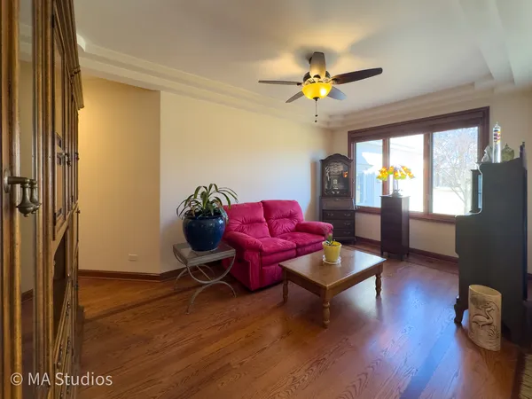 a living room with furniture and wooden floor
