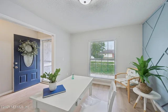 a living room with furniture potted plant and a window