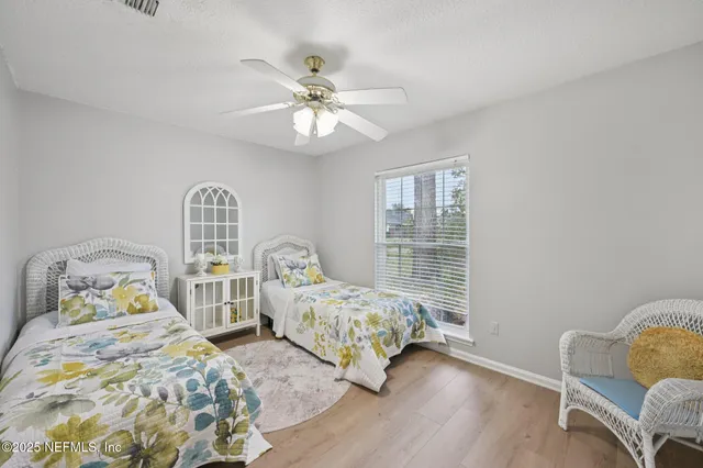 a bedroom with two beds and a chandelier