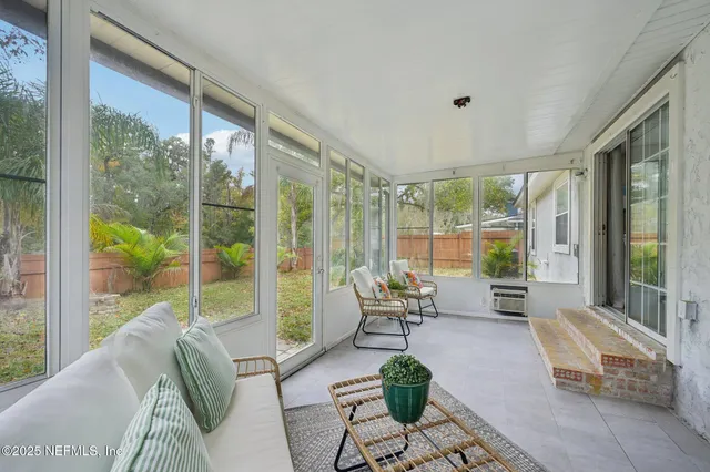 a backyard of a house with table and chairs