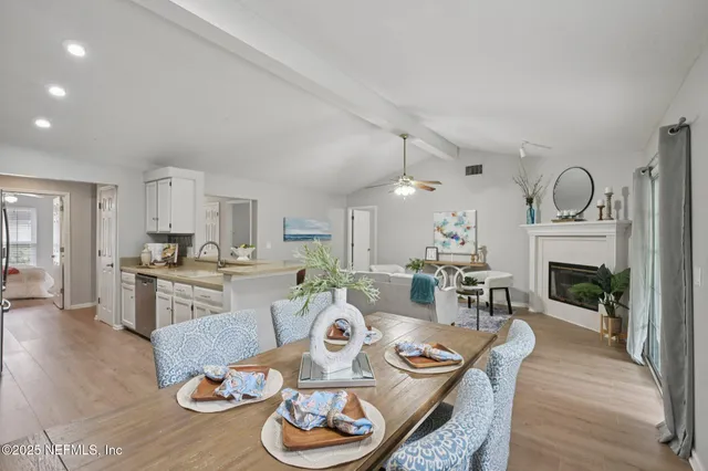 a living room with furniture kitchen view and a fireplace